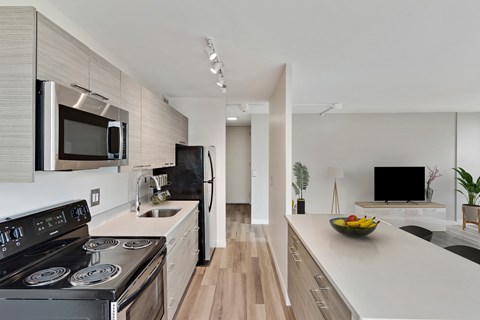 a kitchen with an island and a stove and a microwave