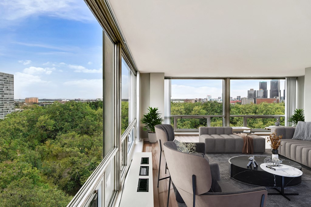 a living room with a large window and a view of the city at The Pavilion, Detroit, MI