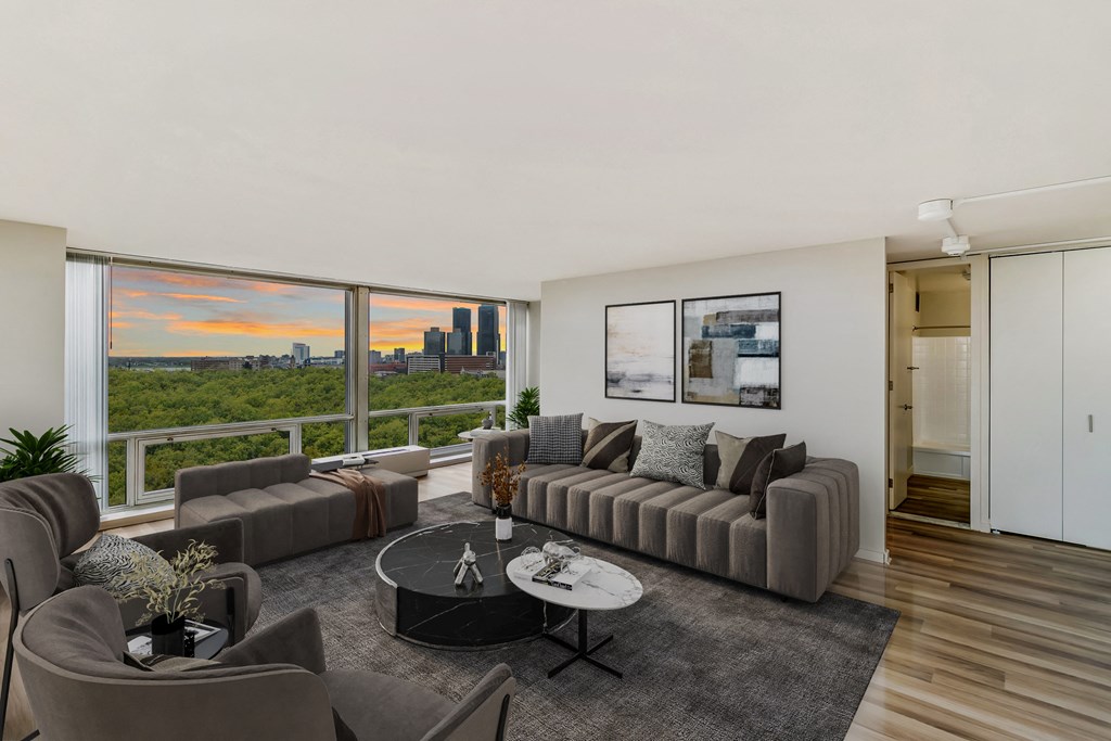 a living room with a large window and a view of the city at The Pavilion, Detroit, Michigan