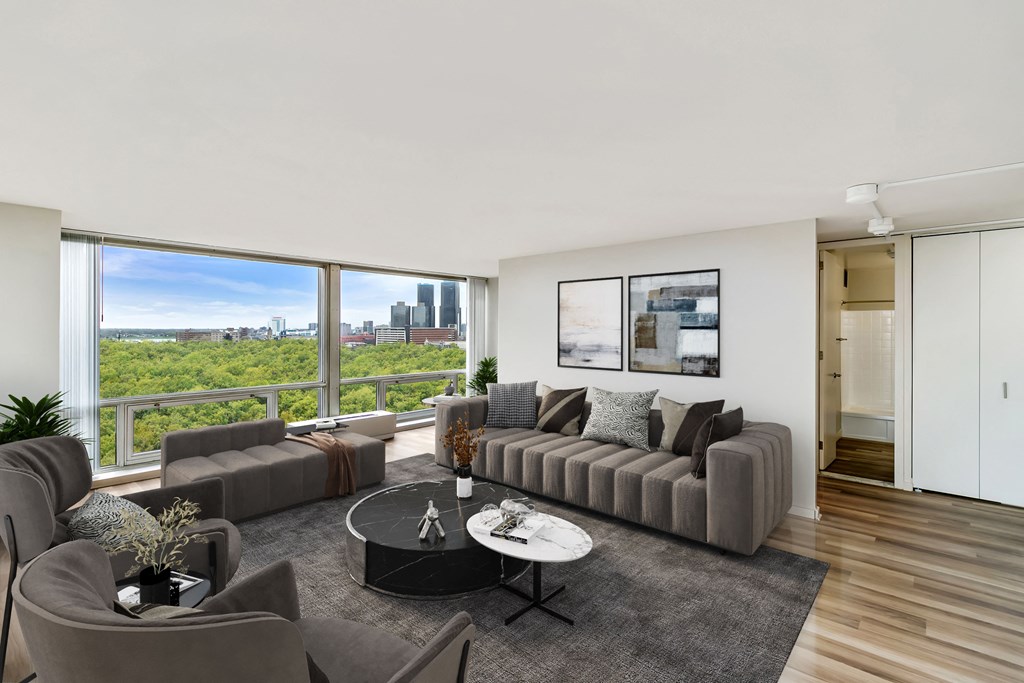 a living room with a large window and a view of the city at The Pavilion, Michigan