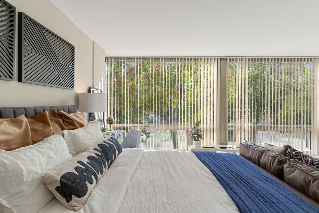a bedroom with a large bed and a large window at the Pavilion at The Pavilion, Detroit, Michigan