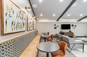 Dining area in the clubhouse of The Waverly with seating and flatscreen TV on Lake Belleville - Photo Gallery 5