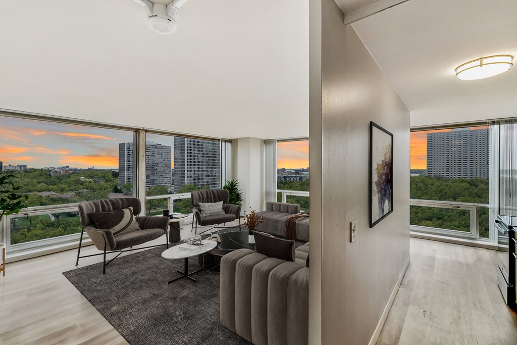 a living room filled with furniture and a large window at The Pavilion, Detroit, MI