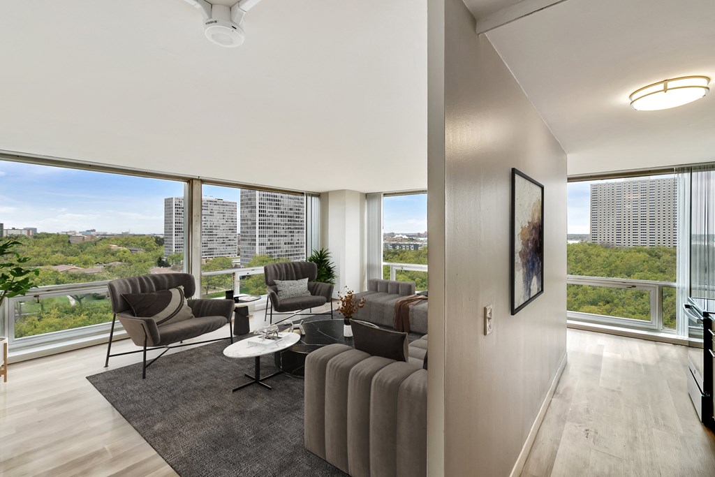 a living room with a large window and a view of the city at The Pavilion, Detroit