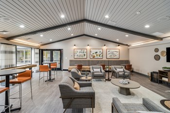 All new modern clubhouse at The Waverly with seating, flat screen TV and floor to ceiling windows. - Photo Gallery 2