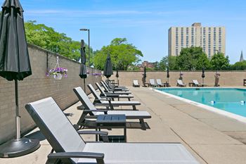 A row of sun loungers are on the patio of a pool at The Pavilion, Detroit