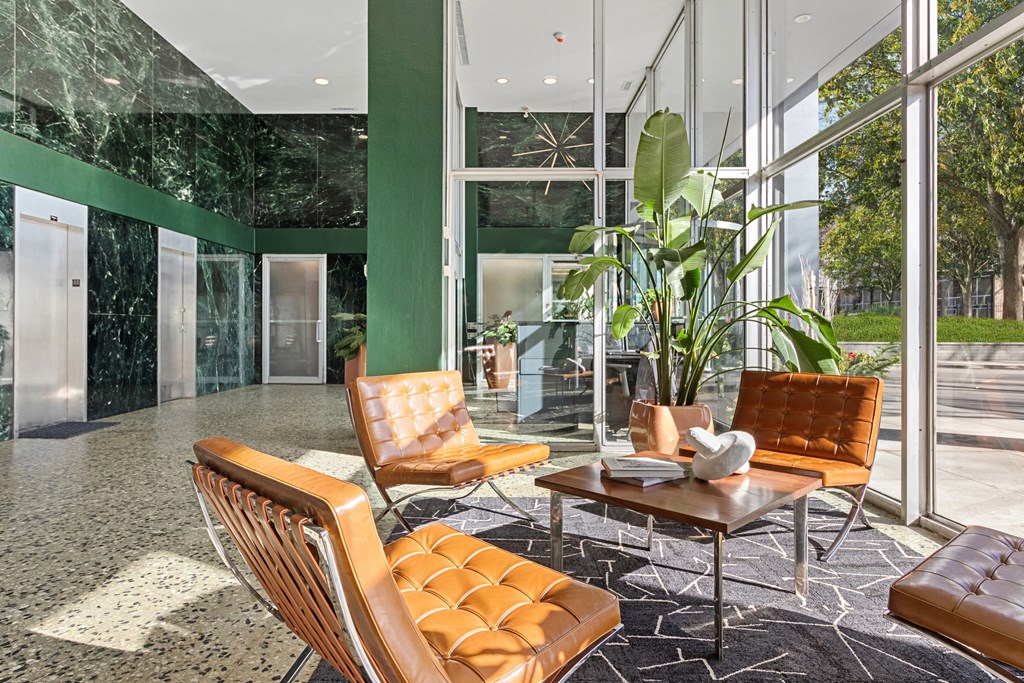 a lobby with leather chairs and a coffee table at The Pavilion, Detroit, Michigan