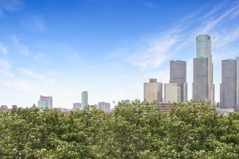 a city skyline with trees in the foreground at The Pavilion, Detroit, MI, 48207
