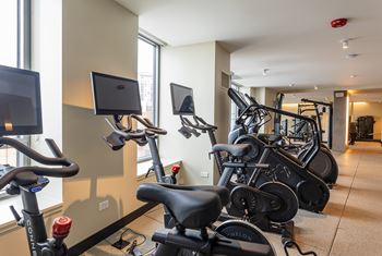 A gym with exercise bikes and treadmills at Kingsbury Plaza Apartments, Illinois, 60654