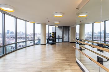 A spacious dance studio with mirrors on the wall and wooden floors at Kingsbury Plaza Apartments, Chicago 60654