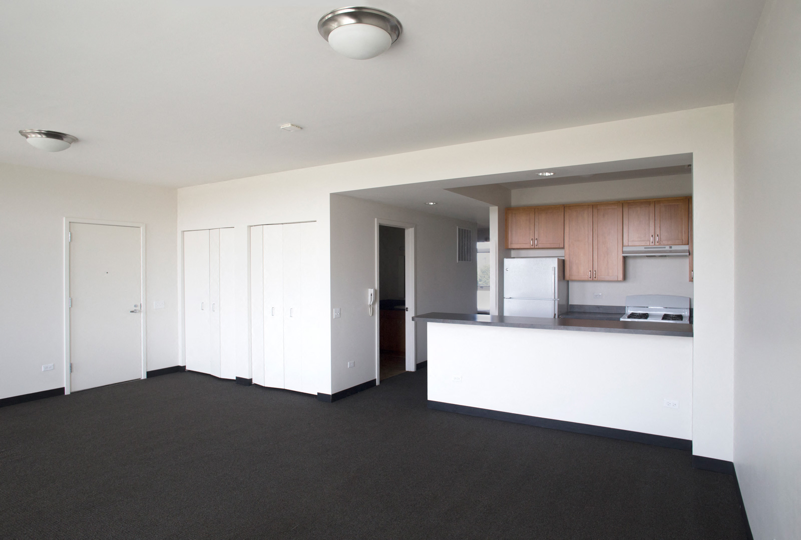 Image of Park boulevard IIB living room with view into kitchen area, and entry way