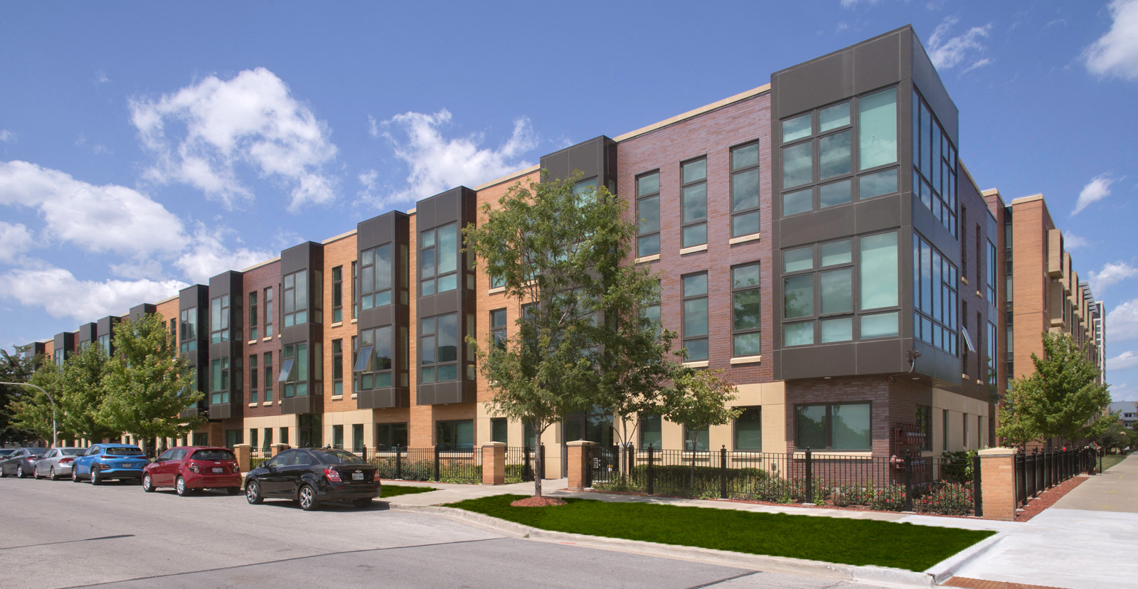 Corner exterior streetview image of one of the Park Boulevard IIB buildings, plus surrounding neighborhood