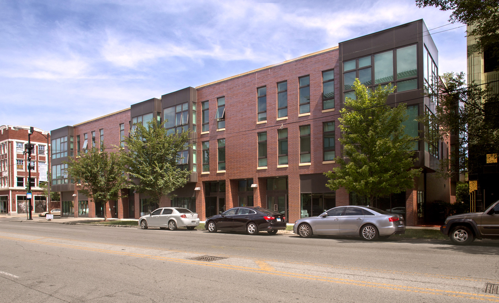 Exterior image of one of the Park Boulevard IIB buildings, plus surrounding neighborhood