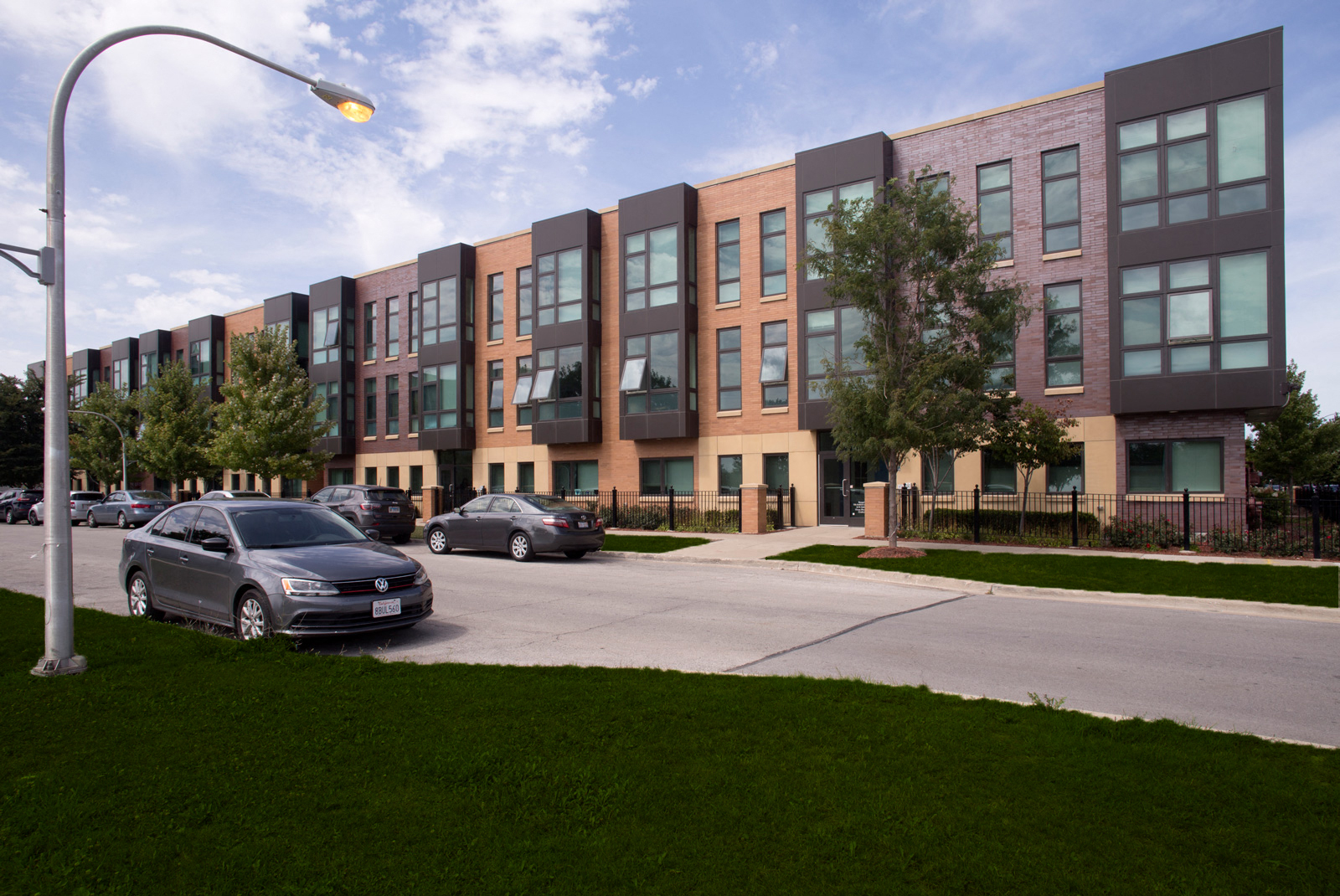 Exterior street view image of one of the Park Boulevard IIB buildings, plus surrounding neighborhood