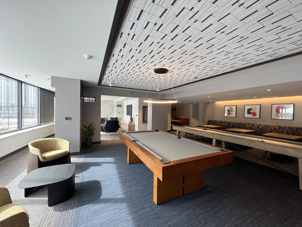 A room with a pool table and a shuffleboard table at Kingsbury Plaza, IL, 60654