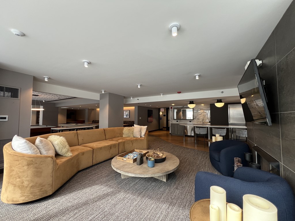 A modern living room with a large sofa and a coffee table at Kingsbury Plaza, Chicago, Illinois