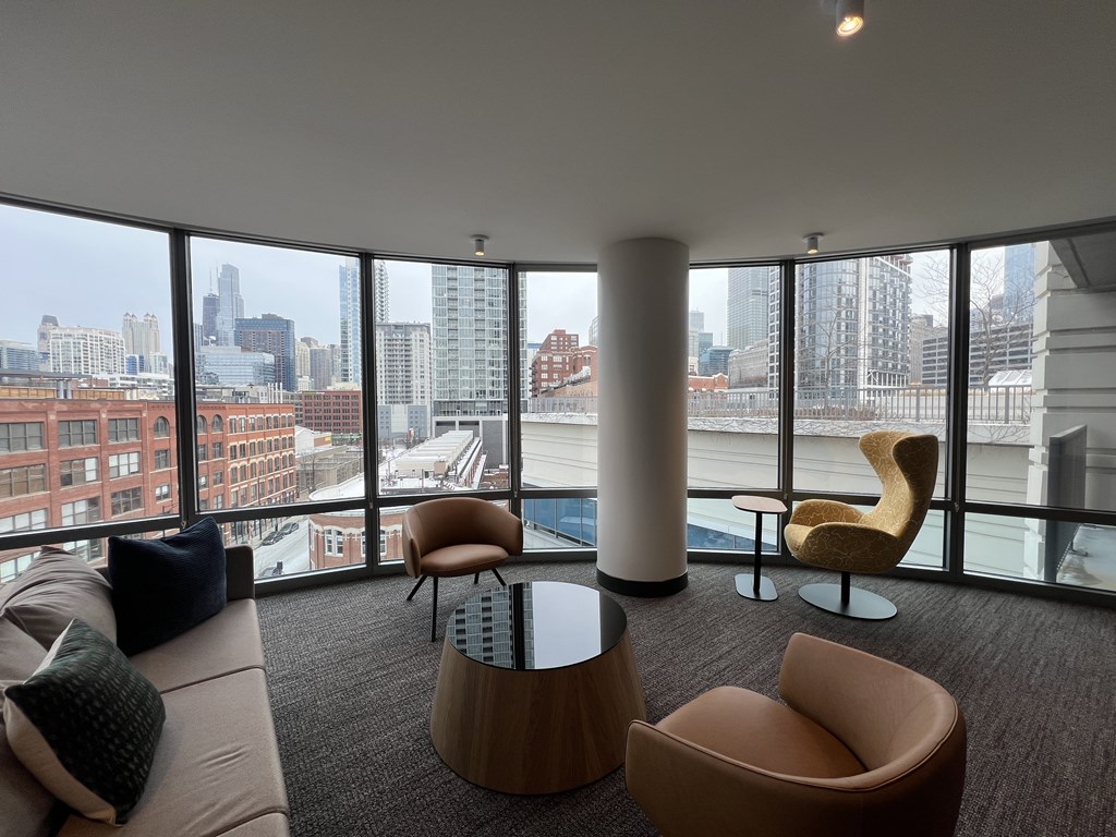 A living room with a view of the city skyline at Kingsbury Plaza, Chicago, IL, 60654