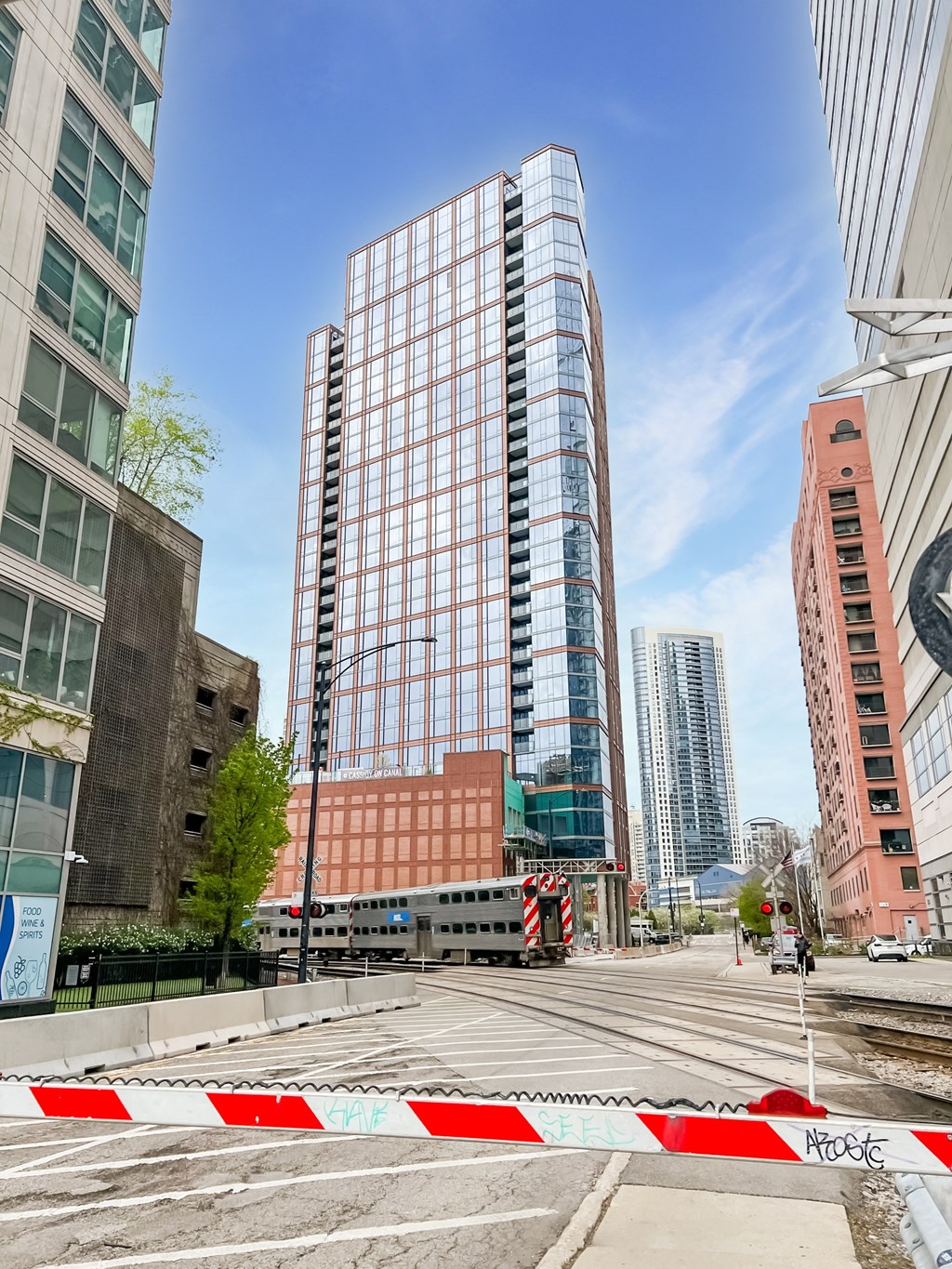 an empty street in a city with tall buildings  at Cassidy on Canal, Chicago, IL