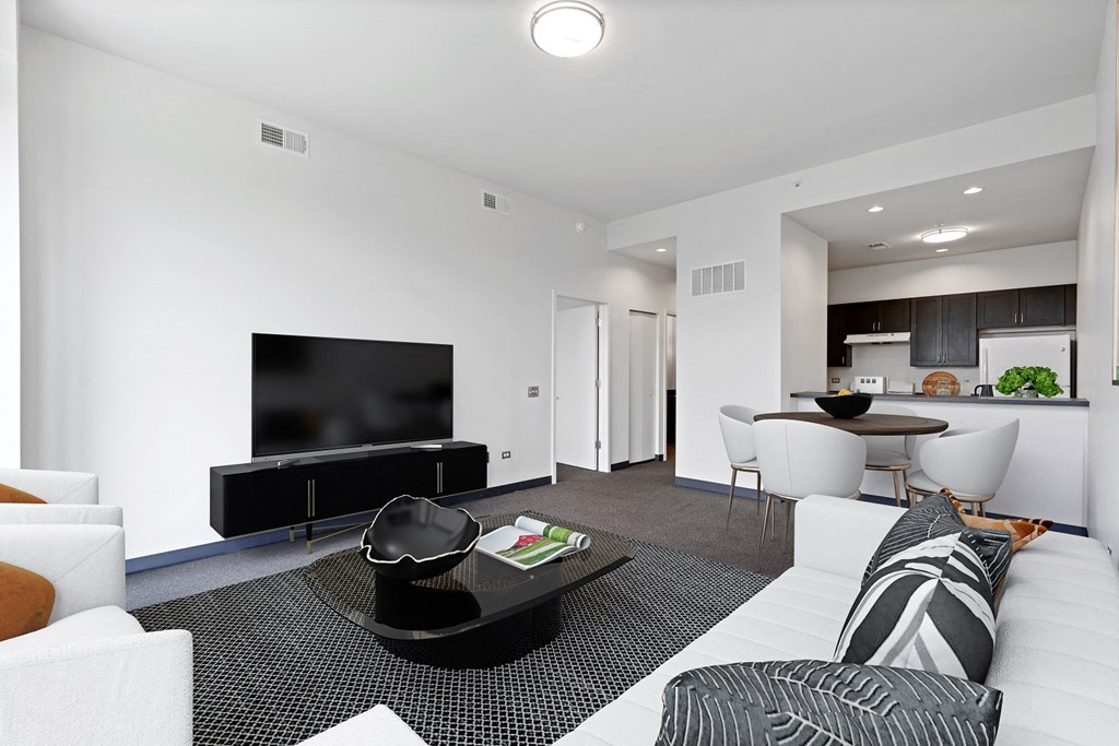 a living room with a white couch and a tv