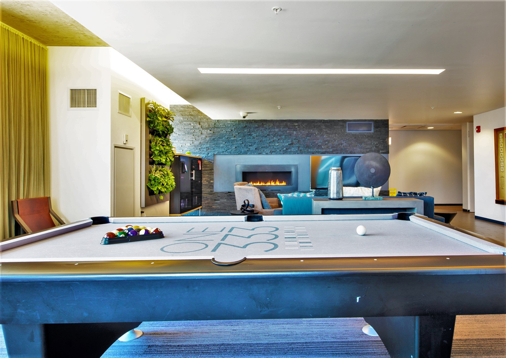 a pool table with a fireplace in the background at One 333, Chicago, 60605