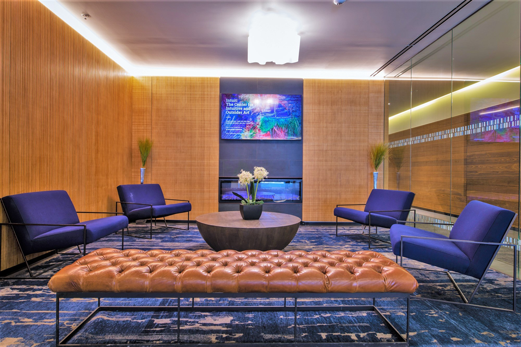 a room filled with furniture and a large screen at One 333, Chicago, IL