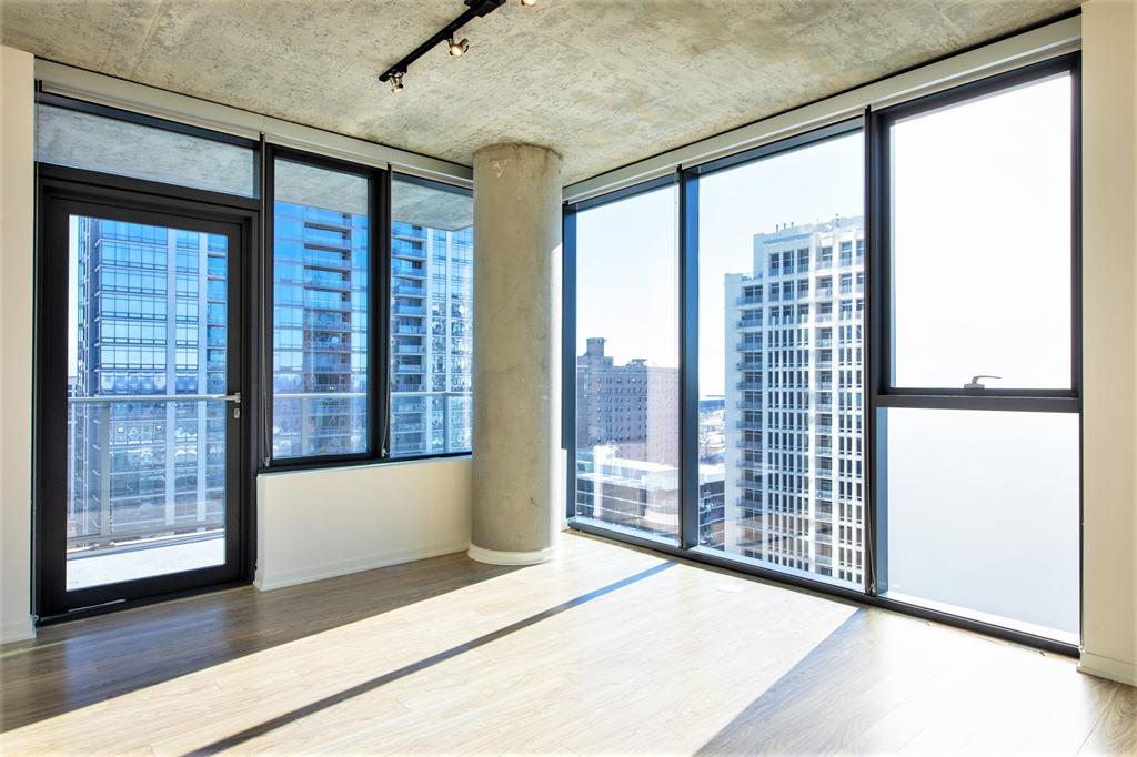 an empty living room with a view of the city at One 333, Chicago, IL, 60605