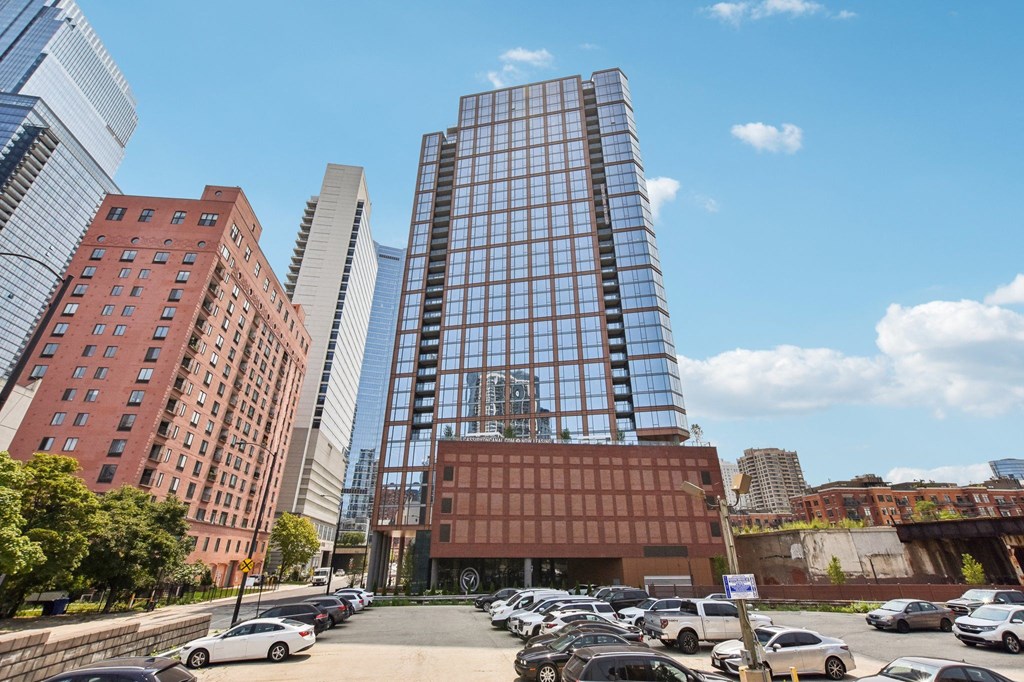 a parking lot in front of a tall building in the city at Cassidy on Canal, Chicago, IL