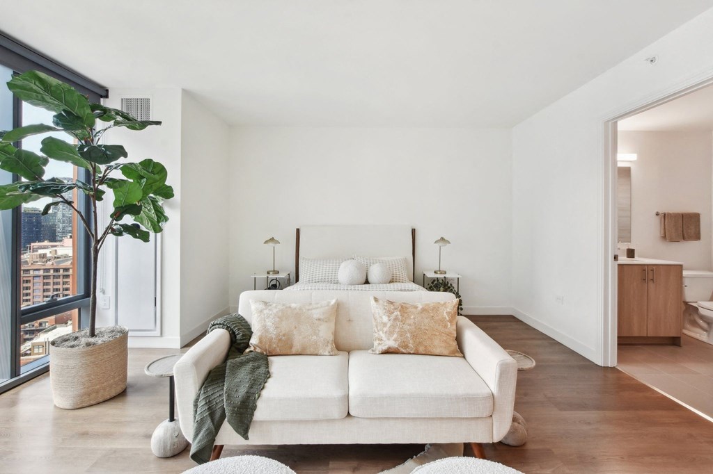 a bedroom with a couch and a bed and a large window at Cassidy on Canal, Chicago, IL, 60654
