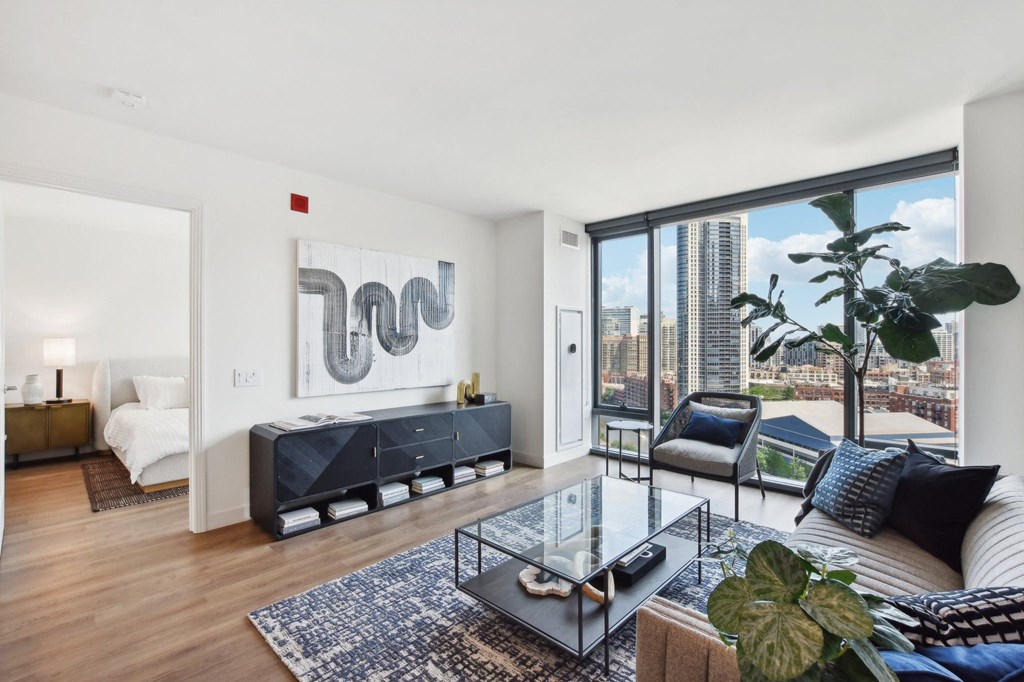 a living room with a large window and a couch and a table at Cassidy on Canal, Chicago, IL, 60654