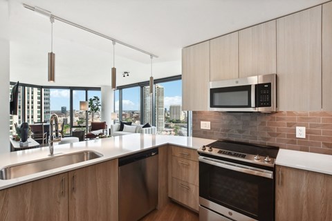 a kitchen with a sink and a stove and a window