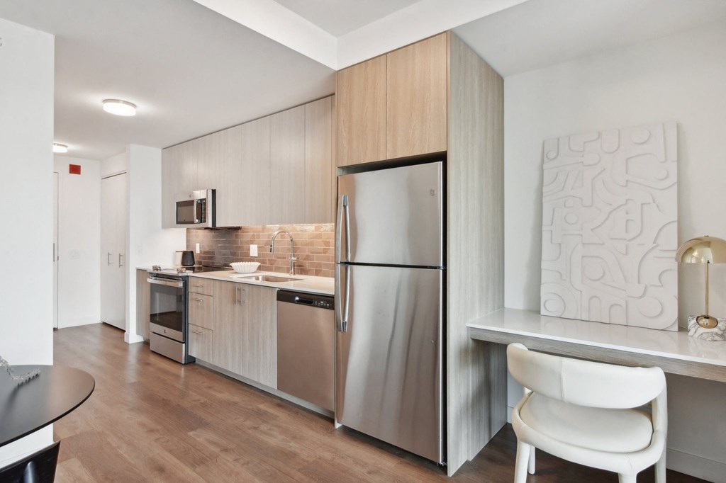 a kitchen with stainless steel appliances and a counter top with a refrigerator at Cassidy on Canal, Chicago, Illinois