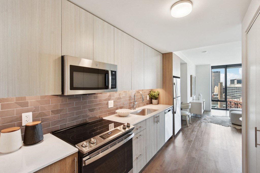 a kitchen with white cabinets and a sink and a microwave at Cassidy on Canal, Chicago, IL, 60654