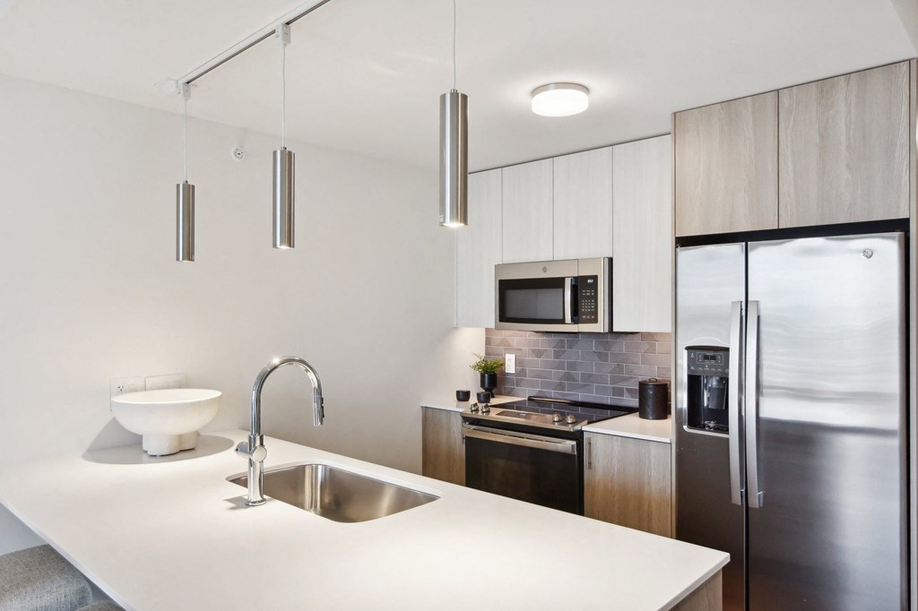 a kitchen with a sink and a refrigerator at Cassidy on Canal, Chicago, IL, 60654