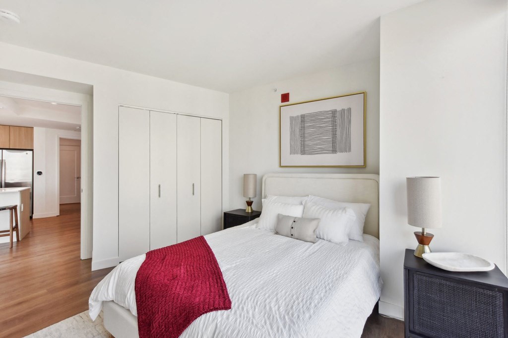 a bedroom with a white bed and a red blanket at Cassidy on Canal, Chicago
