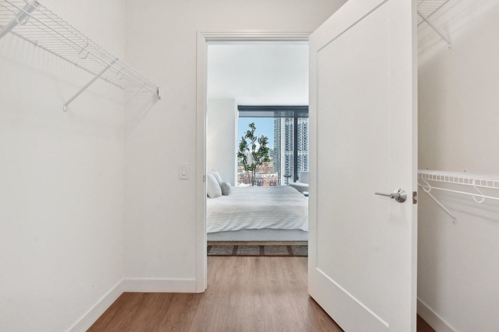 a bedroom with a bed and a door to a closet at Cassidy on Canal, Chicago, IL, 60654
