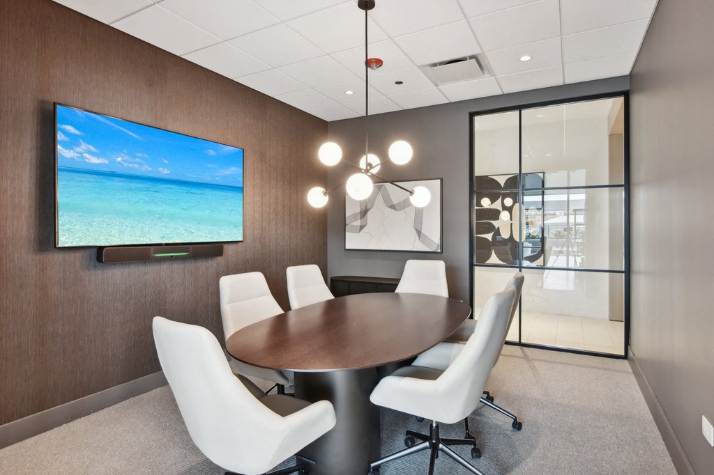 a conference room with a table and chairs and a television at Cassidy on Canal, Chicago, IL, 60654