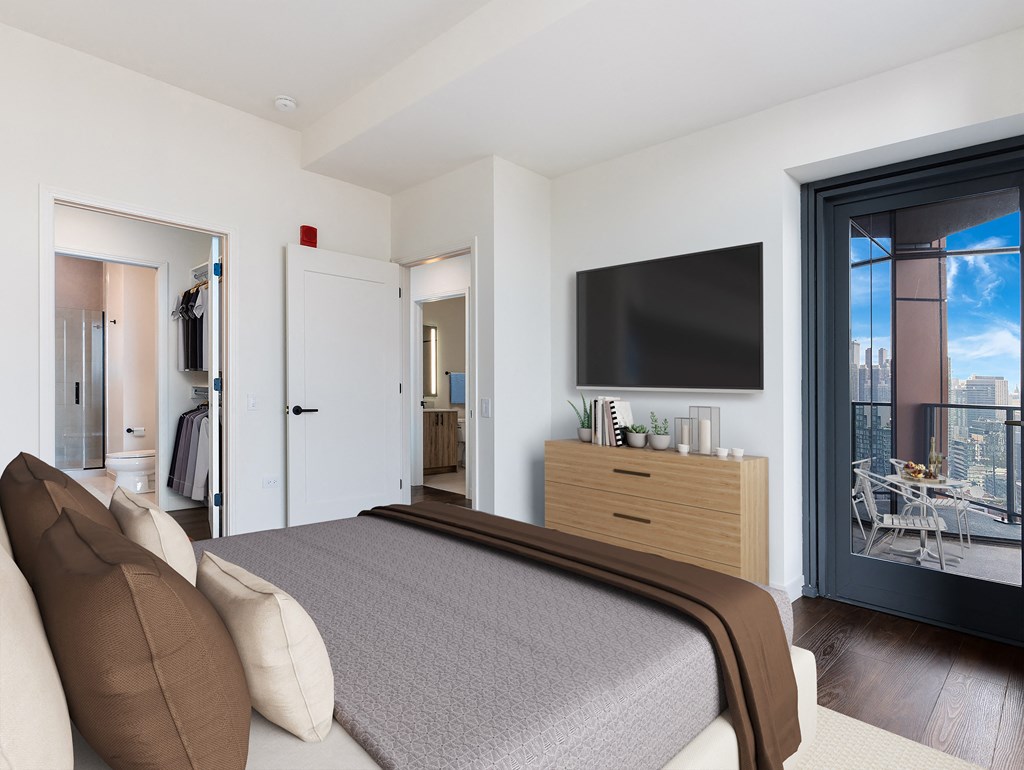 a bedroom with a large bed and a tv on the wall at Cassidy on Canal, Chicago, IL