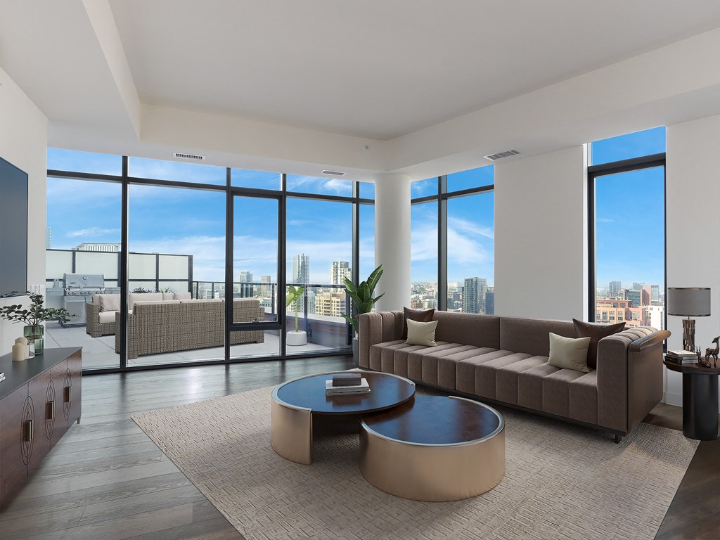 a living room with a couch and a coffee table in front of windows at Cassidy on Canal, Chicago, IL