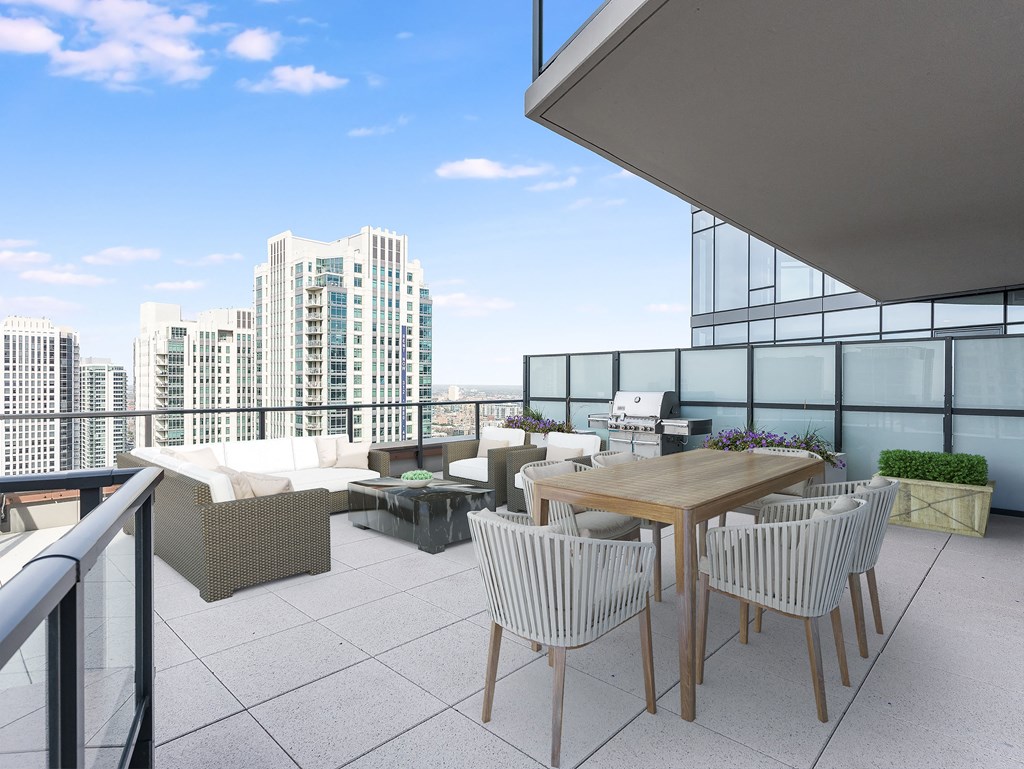a rooftop terrace with a table and chairs and a view of the city at Cassidy on Canal, Chicago, Illinois, 60606
