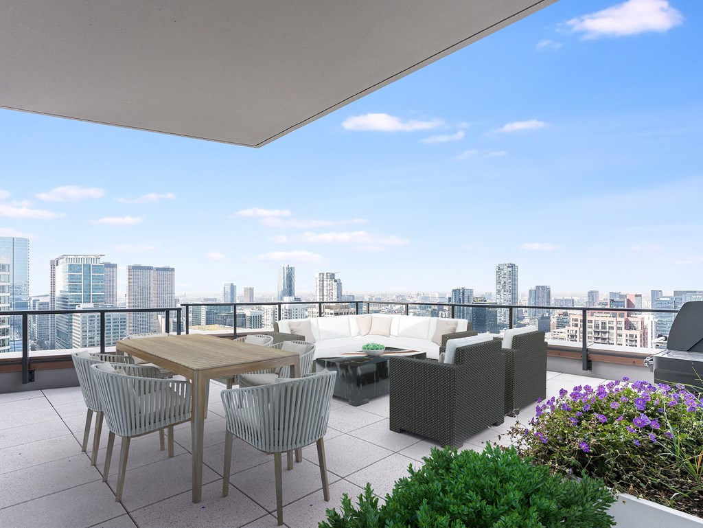 a balcony with a view of a city and a table and chairs at Cassidy on Canal, Chicago, Illinois, 60606