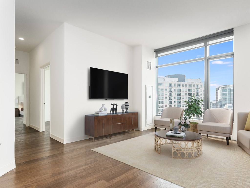 a living room with a large window and a television at Cassidy on Canal, Chicago, Illinois