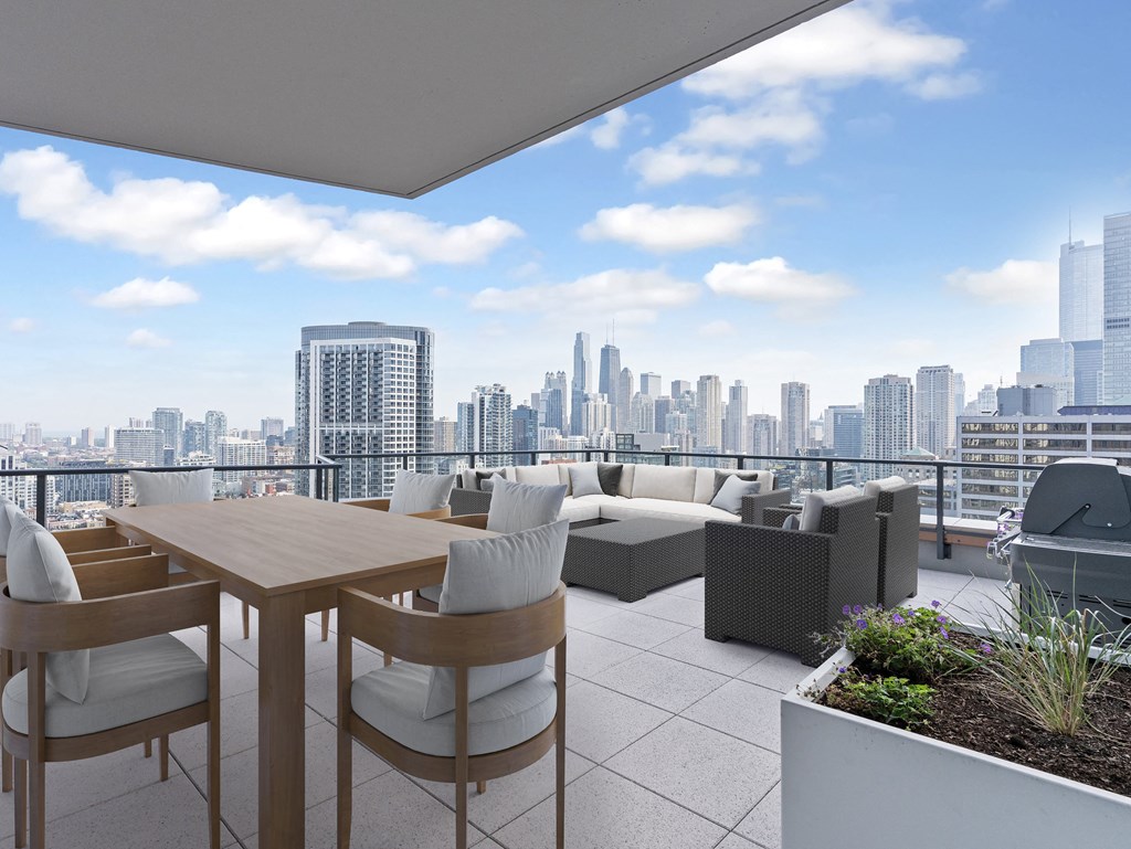 a terrace with a table and chairs and a view of the city at Cassidy on Canal, Chicago, 60606