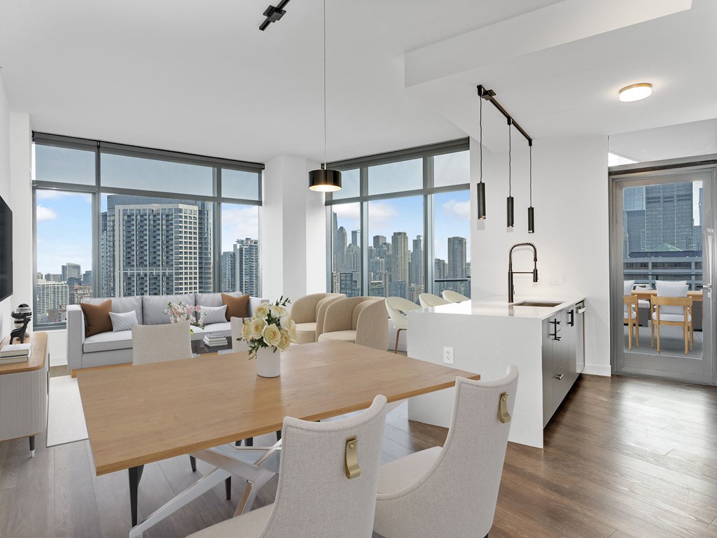 a living and dining room with a city view and a table and chairs at Cassidy on Canal, Chicago