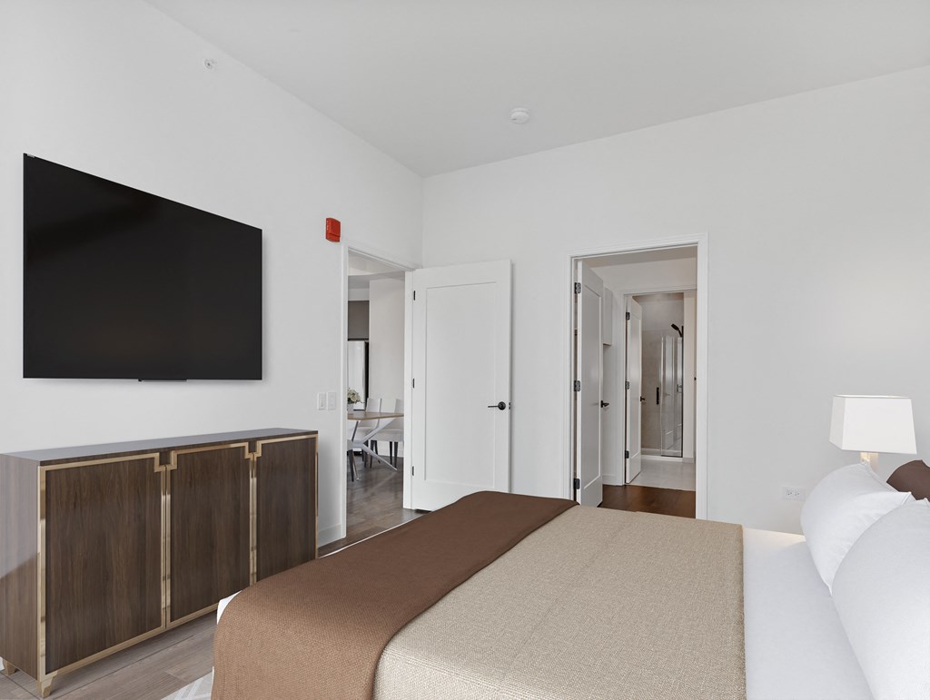 a bedroom with a bed and a tv on the wall at Cassidy on Canal, Chicago, IL