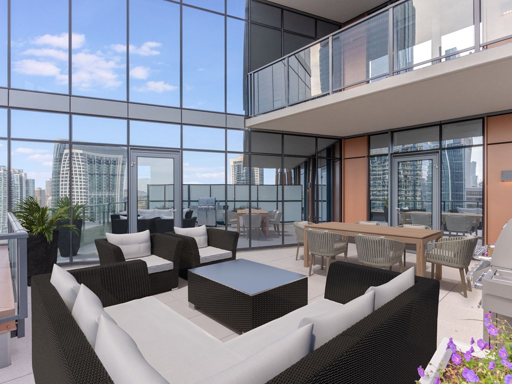 a living room with couches and a table in front of windows at Cassidy on Canal, Chicago, 60606