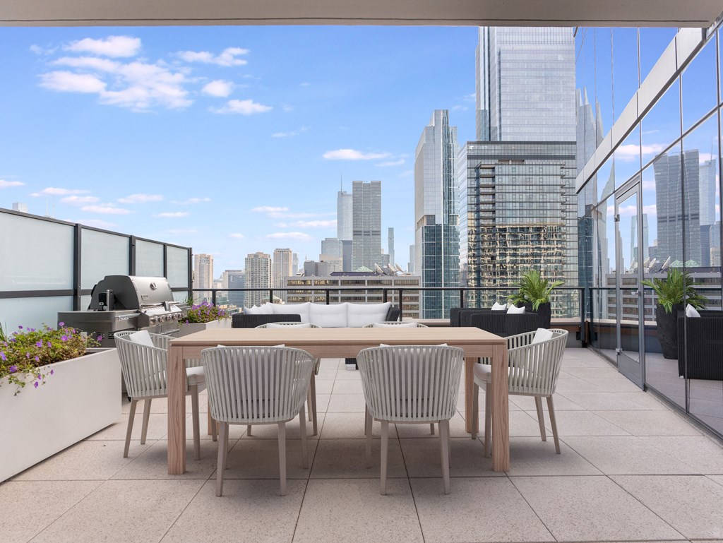 a communal terrace with a table and chairs and a view of the city at Cassidy on Canal, Chicago, Illinois, 60606