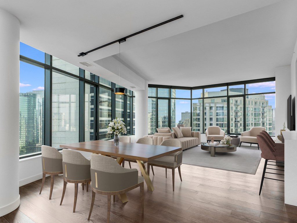 a large living room with a large table and chairs and a view of the city at Cassidy on Canal, Chicago, IL