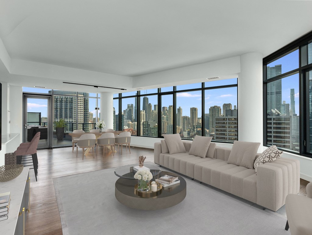 a living room with a white couch and a table and a view of the city at Cassidy on Canal, Chicago, Illinois, 60606