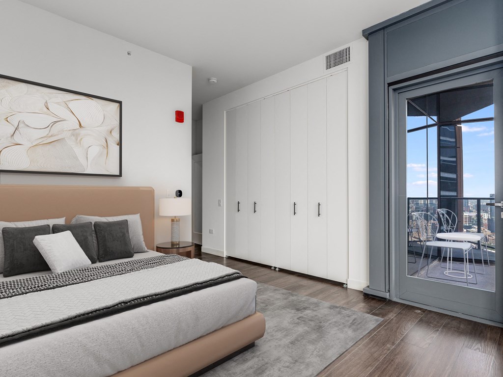 a bedroom with a bed and a sliding glass door to a balcony at Cassidy on Canal, Chicago, 60606
