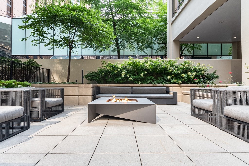Outdoor patio with a firepit and lounge furniture at Columbus Plaza, Chicago, 60601